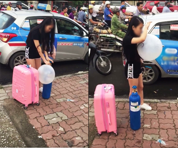 Cô gái trẻ kéo theo bình khí, hít bóng cười trên đường phố Hà Nội
